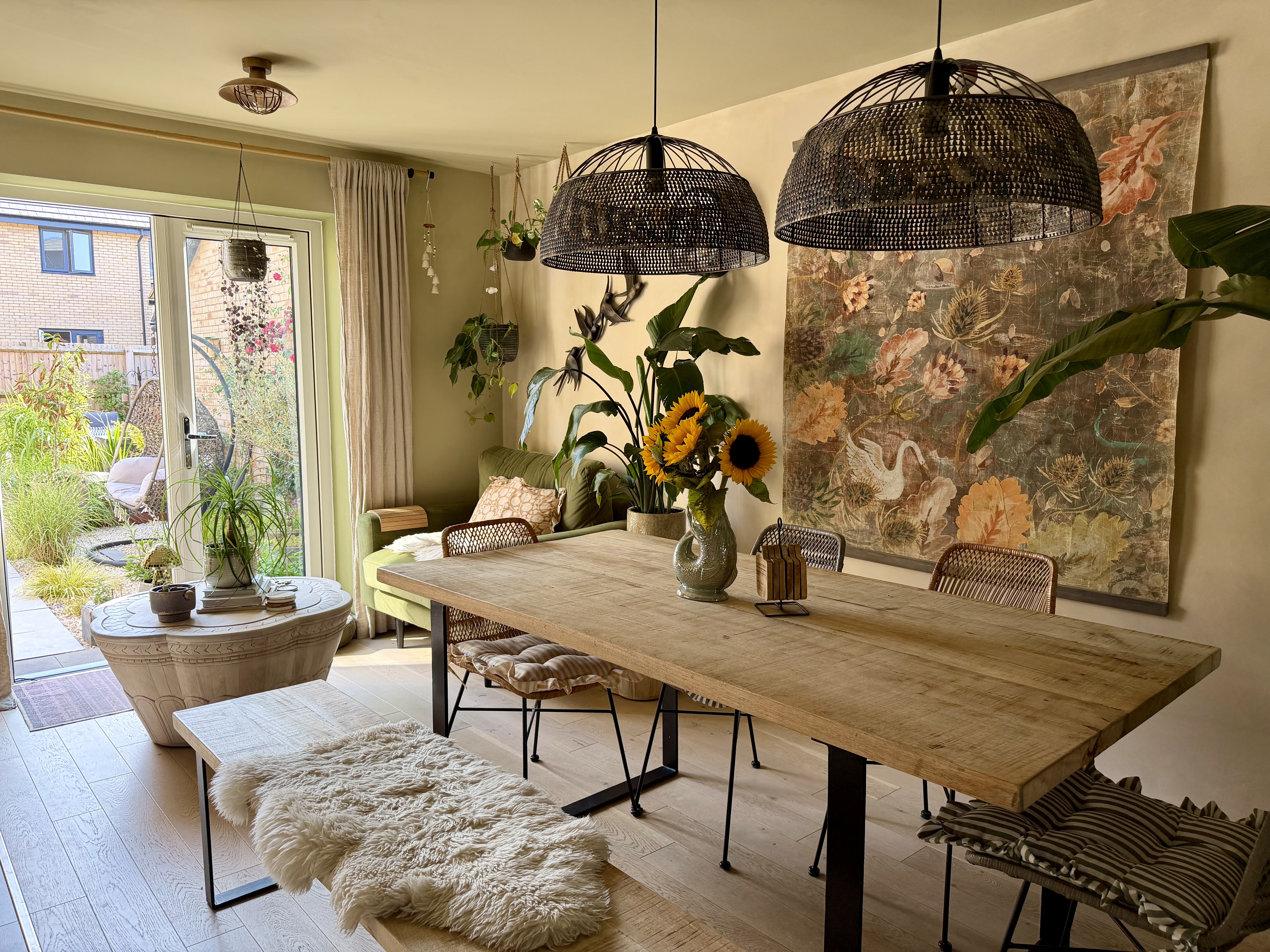 Dining room styled with sunflowers and botanical artwork